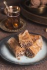 Baklava turc avec thé dans une table rustique — Photo de stock