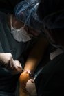 Surgeons making Achilles operation — Stock Photo