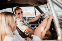 Cheerful man looking at camera taking a ride with a girlfriend — Stock Photo