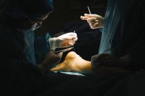 Хирург зашивает Ахиллесово сухожилие — стоковое фото