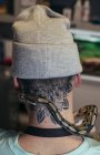 Snake creeping on male neck with tattoo — Stock Photo