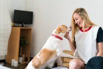 Woman playing with her dog — Stock Photo