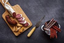 Board with sliced salami — Stock Photo