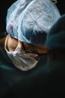 Surgeon in mask looking down — Stock Photo
