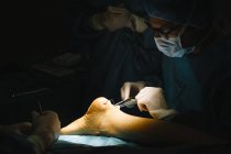 Surgeon making Achilles tendon operation — Stock Photo