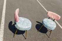Two vintage chairs on asphalt road — Stock Photo