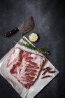 Directly above view of raw pork ribs with spices on towel — Stock Photo