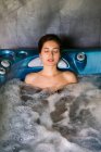 Woman relaxing in jacuzzi — Stock Photo
