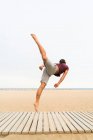 Homem praticando saltos na praia — Fotografia de Stock