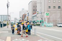 Enfants portant des casques marchant sur le trottoir — Photo de stock