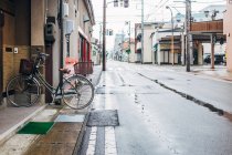 Lonely bicycle parked on pavement — Stock Photo