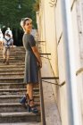 Pretty woman posing on stairs — Stock Photo