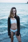 Young sensual woman posing on beach — Stock Photo