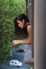 Girl peeking out the window — Stock Photo
