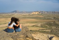 Excited women lying on cliff — Stock Photo
