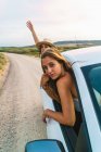 Women hanging out of car — Stock Photo