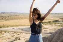 Excited woman standing on hill — Stock Photo