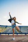 Жінка стрибає на мосту — стокове фото