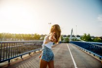 Femme gaie posant sur le pont — Photo de stock