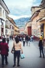 AYACUCHO, PERÚ - 30 DE DICIEMBRE DE 2016: Gente local caminando en la calle con montaña a lo lejos - foto de stock