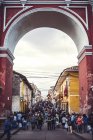 Ayacucho, Peru - 30. Dezember 2016: Menschenmenge läuft durch monumentalen Bogen — Stockfoto