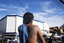 PHILIPPINES - 10 February, 2014: Back view of shirtless man with jesus tattoo on back — Stock Photo