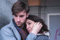 Young couple hugging during dramatic scene in street. — Stock Photo