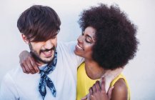 Interracial couple embracing and looking at each other — Stock Photo