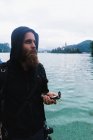 Bearded man holding compass — Stock Photo