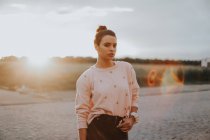 Чувственная девушка позирует над сельским полем на закате — стоковое фото