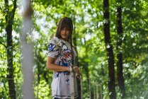 Junge brünette Frau posiert im Wald — Stockfoto