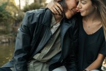 Crop of boyfriend leaning on and embracing girlfriend — Stock Photo