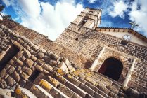 Tilt shot of antique church placed on ancient Inca temple — Stock Photo