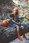 Girl in costume posing on tree — Stock Photo