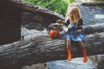 Girl in costume posing on tree — Stock Photo