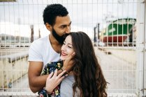 Sensual couple near wharf fence — Stock Photo