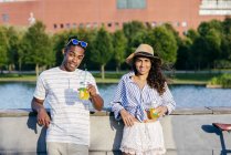 Couple with refreshing drinks looking at camera — Stock Photo