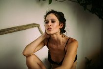 Portrait of brunette woman wearing black lingerie and looking away with half open mouth — Stock Photo