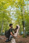 Man and woman embracing in woods — Stock Photo