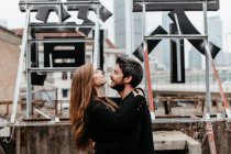 Side view of couple hugging each other on rooftop — Stock Photo