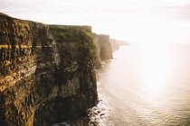 Plumb cliff over calm sescape — Stock Photo