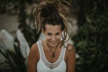 High angle portrait of smiling woman with dreadlocks looking at camera — Stock Photo