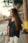 Portrait of brunette girl posing at street scene and looking away — Stock Photo