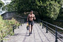 Bodybuilder man using smartphone — Stock Photo