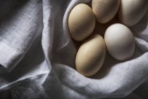 From above white eggs on rural towel — Stock Photo