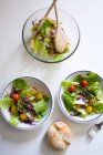 Diretamente acima vista de tigela e pratos com salada na mesa — Fotografia de Stock