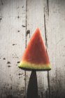 Wedge of fresh watermelon stacked on knife — Stock Photo