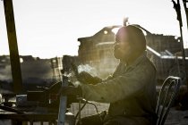 Man sitting and doing welding — Stock Photo