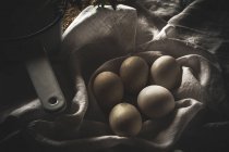 From above chiken eggs on rustic table with scoop — Stock Photo