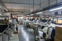 Tanger, Marokko - 18. April 2016: Blick auf industrielle Nähmaschinen und Maschinisten, die in einer Linie arbeiten — Stockfoto